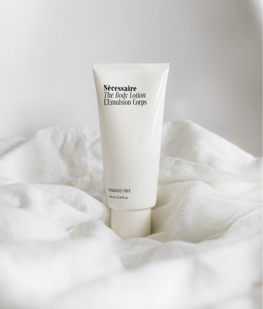 A photo showing a white tube resting on a white fabric.