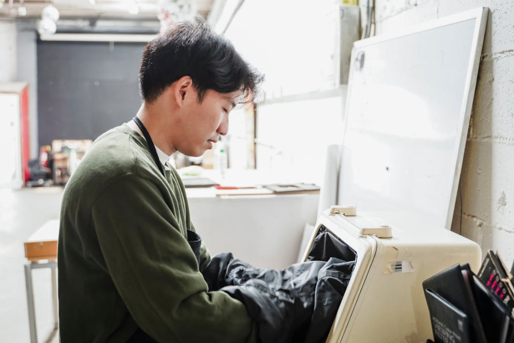man-putting-his-hands-in-a-machine-in-an-industry