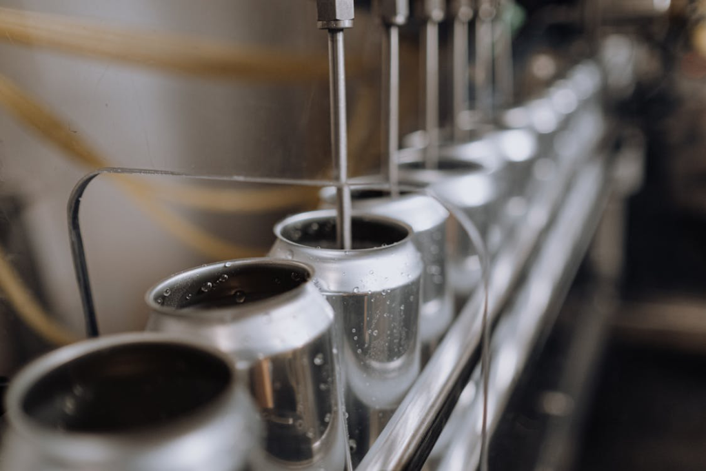 A line of bottles being commercially filled.