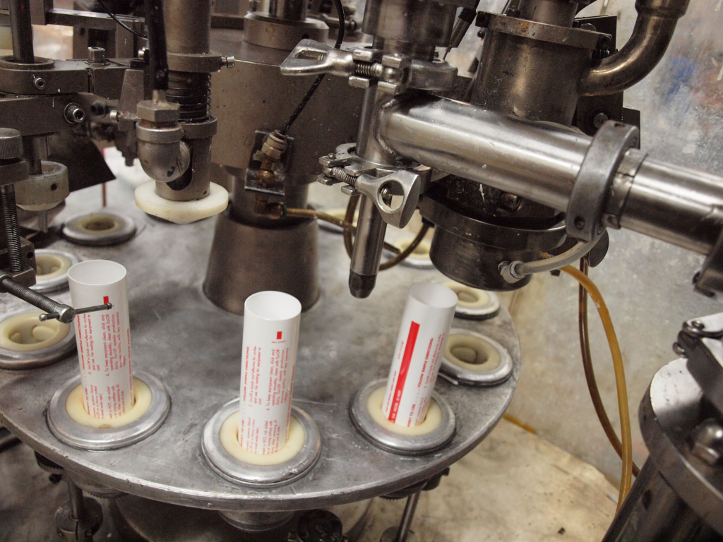 Tube filling with machinery.