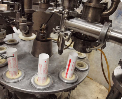 A large machine filling up tubes.