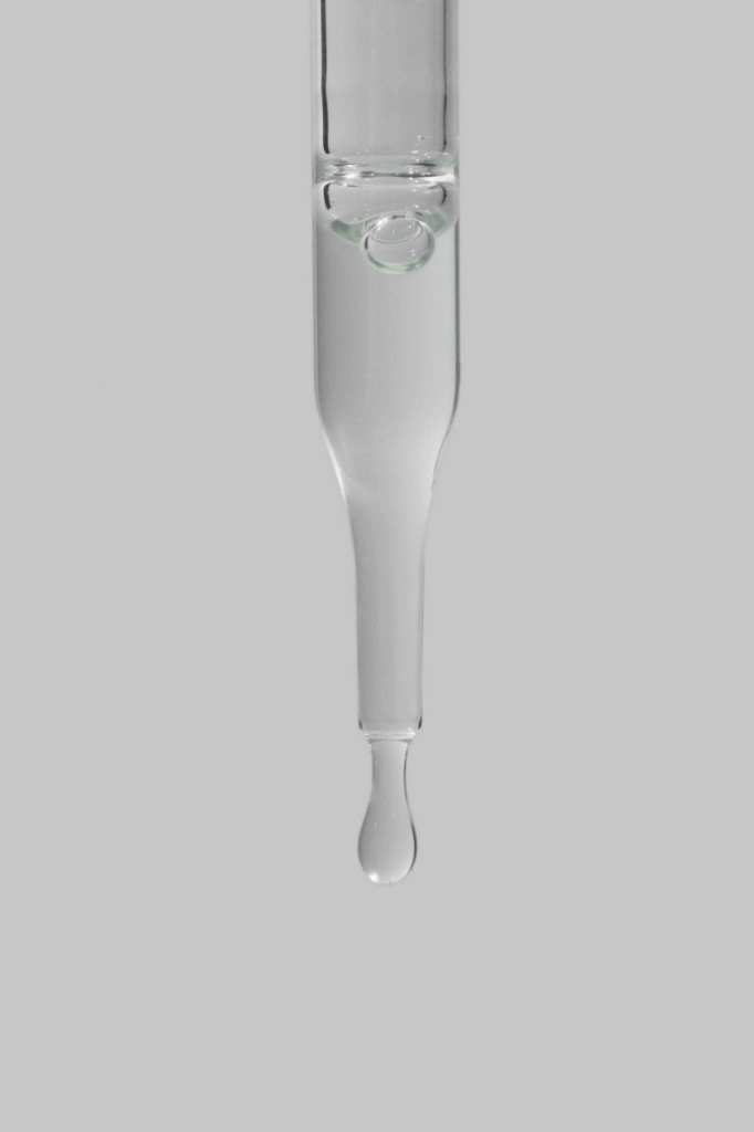 Pipette dispensing a liquid drop