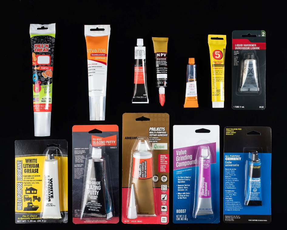 Various filled tubes of personal care products arranged neatly