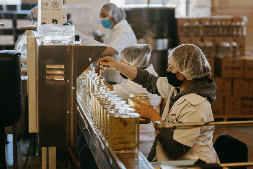 Workers inspecting product consistency on the filling line.