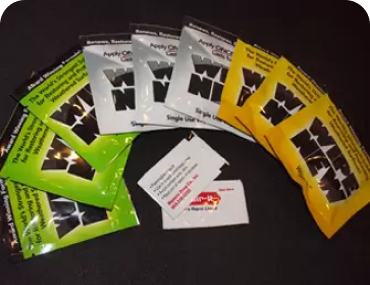 Three colored pouches laid out on a black background.