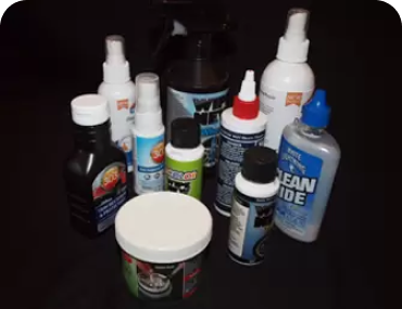 everal bottles lined up together on a black platform.